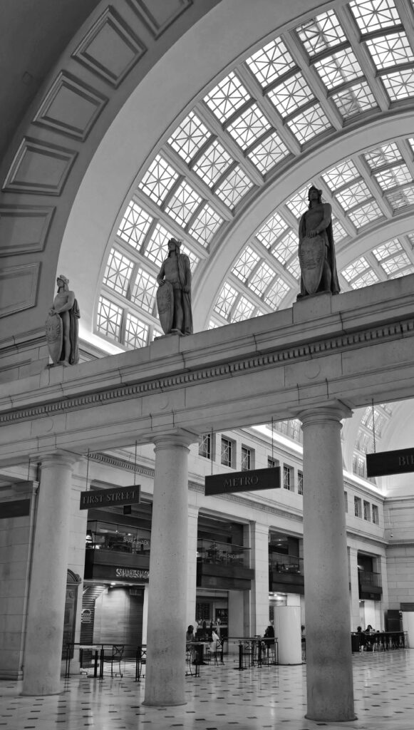 NYC Penn Station scene with stone statues